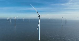 Wind turbines at the Afsluitdijk on water, converts the kinetic energy of wind into sustainable electrical energy, wind farms, renewable energy in The Netherlands.