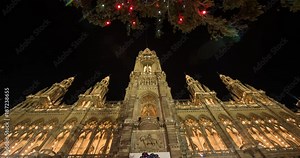 VIENNA, AUSTRIA – DECEMBER 2015 : Moving timelapse of Rathaus / City Hall on slider at night with christmas tree in view