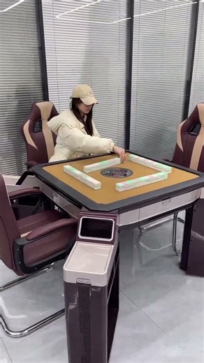 a modern, fully automatic electric mahjong table a built-in shuffling mechanism and side console.