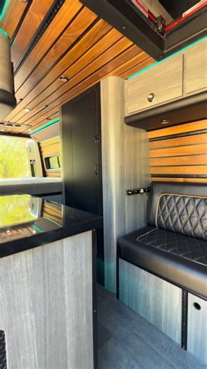 Automotive Designs and Fab on Instagram: "The Mench is a purpose-built conversion made for a creator, musician, and podcaster who lives life on the road. This custom Sprinter van features a front workspace with integrated recording mounts, black L-Track system for cameras and microphones, walnut accent panels for an elevated studio aesthetic, upper storage with our signature rounded cabinetry, and a massive rear gear garage with a full pull-out tray for studio equipment and instruments. But this