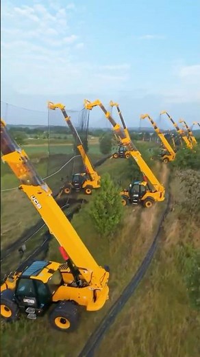 Driving range netting held up by 22 JCB Loadalls