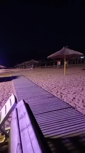 Beach Night Scene with Umbrellas and Lights