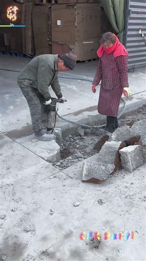 High frequency electric chisel breaks concrete floor