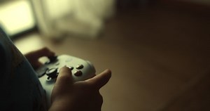 Child gamer hands holding modern console for play station close-up, guy playing video games. Using controller playing video games - close up of hands and joypad
