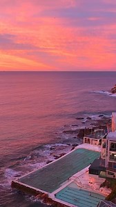 Catch a breathtaking winter #sunrise at #bondibeach. 💜 Watch as the early risers run along the shore, surfers catch the perfect waves, and swimmers dive into the crisp morning sea. Thanks for sharing your #feelnewsydney moment IG/dario.bs ID: People exercising and having fun at Bondi Beach during sunrise in Sydney, Australia. | Sydney.com