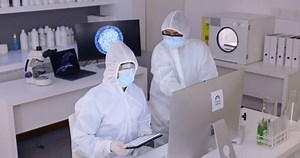 Scientist team in laboratory, PPE and computer, science study for medical research with collaboration. People in hazmat, data analysis and discussion of test results with tablet and biotechnology