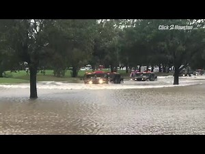 Humvees going through high water in Katy