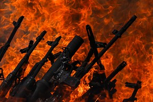 PKK fighters cast weapons into fire to mark start of disarmament