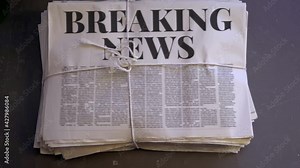 Newspaper stack being dropped onto the floor Stock Video