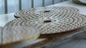 Molds for squeezing dough and shaping pasta. Different types of pasta molds in a macaroni factory. Industrial production of pasta. Macaroni factory and pasta production stages. Spaghetti manufacturing