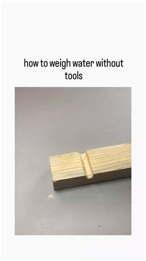 Trend Decodes on Instagram: "The X post features a 19-second DIY video demonstrating how to build a simple hydrostatic balance scale using scrap wood, clear tubing, glue, a ruler, and dyed water, enabling weight measurement via equalized liquid levels in a U-tube setup. Drawing on Pascal's principle of communicating vessels, the method equates water displacement height to mass (1 ml = 1 g), offering a tool-free alternative for precise weighing in resource-limited scenarios, as confirmed by basic