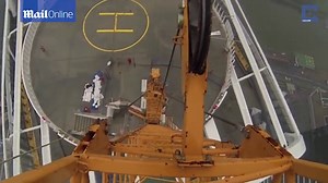 Stomach churning photos show daredevils dangling off tall buildings