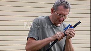 Compression connection of polyethylene pipes using collet clamp, man connects ball valve connector.
