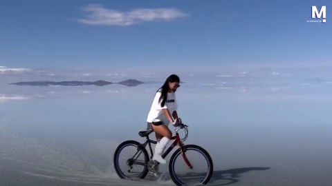 Woman 'rides a bike in the sky' in Bolivia's Salar de Uyuni