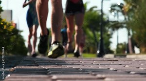Background with blurry running people copy space. Marathon, a crowd of people running. Slow Motion. Unfocused. Blurry. legs runners
