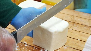 Download Worker slicing the cheese on table , for free