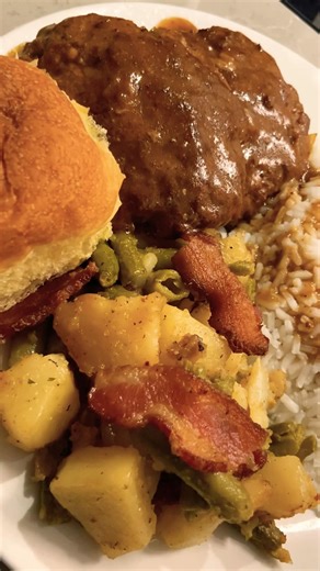 Ground beef and turkey patties smothered in homemade gravy, rice , green beans with bacon & potatoes