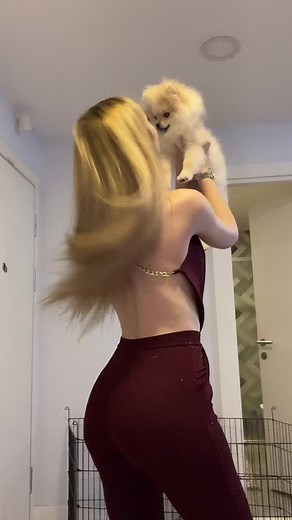 Cute Woman Interacts with Fluffy Dog at Home