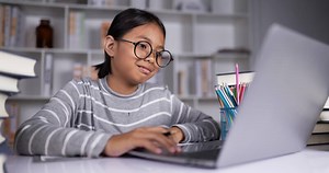 Download Happy teen girl makes conference video call on laptop computer. for free