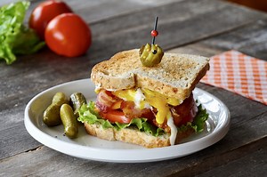 A Classic Dagwood Sandwich with Fried Egg and Cheese