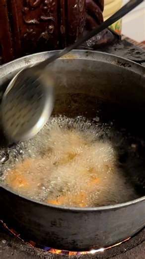 Golden boiled egg halves are dipped, coated, and fried to crunchy perfection. A simple delight in the great outdoors. #OutdoorCooking #EggRecipe #TraditionalCuisine #Cooking | Life of Julia