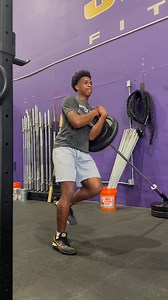 The Landmine Zercher Single Leg Romanian Deadlift (SL RDL) combines...