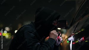 Robber with mask walk checking breaking entering alarm shines a flashlight in a car sitting stealing crime illegal theft stolen danger burglary bandit secure safety money insurance door