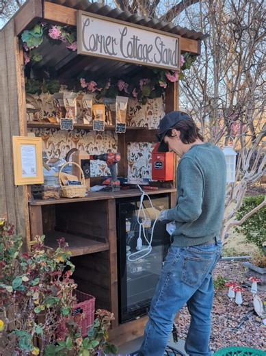The Corner Cottage Stand is getting its cozy glow ✨ Lights going up, goodies on the shelves… and Gwen watching over everything from the porch like the little cottage guardian she is. #southernutah #hurricaneutah #stgeorgeutah #farmstand #bakestand