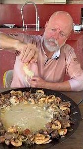 Filet mignon, sausage, chicken hearts, jumbo shrimp with cheese cream on a disc-shaped plate.