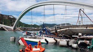 Towering arch bridge falls in Taiwan bay, divers search for victims