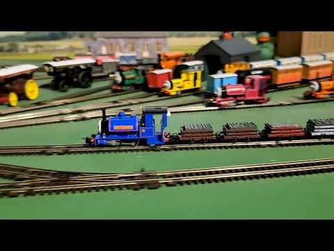 Bachmann sir handel pulling 2 brown, 1 red, 1 grey slate wagons, red box van and blue brakvan