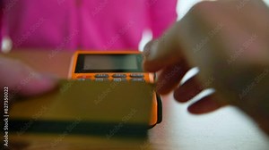 Woman paying by credit card in a coffee shop