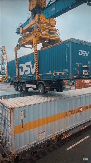 the container lifter crane is lifted the truck container and placed on another container