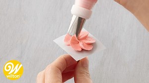 Flower nails make it easy to make buttercream flowers or layers of petals. In this video, learn how to use a flower nail to pipe beautiful icing flowers to decorate cakes, cupcakes, and other desserts. Find the written instructions here: http://ow.ly/3zI750xQACN | Wilton Cake Decorating