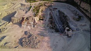 Heavy-Duty Dump Truck backing up to Crusher House in Quarry - Mining Operations and Material Processing. Thornton Illinois Quarry.