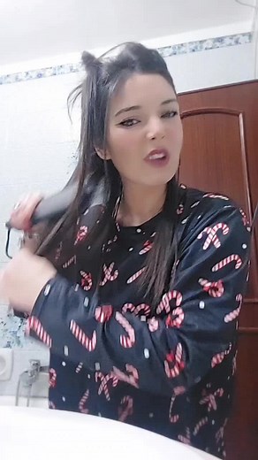 Brushing Long Dark Hair in a Stylish Bathroom Setting