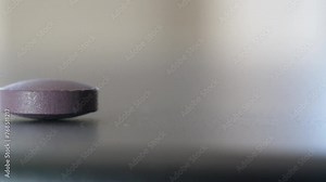 Macro shot of pill on a counter tracking shot dolly to and past, camera moves right to left shallow depth of field