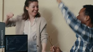 System engineers celebrating successful code compiling doing high five hand gesture with colleague. Coder analyzing algorithm on multiple screens takes off glasses and congratulates coworker.