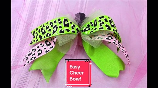 Super Easy DIY Cheer Bow… Here are the Materials you will need to make this awesome cheer bow! Bowdabra Bow Wire (22″) Pink Tulle (6″ x 18″) Green Ribbon (2″ x 14″) Green Cheetah Ribbon (2″ x 14″) Pink Cheetah Ribbon (2″ x 14″) Scrunchy Scissors Lighter #BowdabraDIY #abrabowdabra #bowdabra #bowmaking #hairbows #minibowdabra