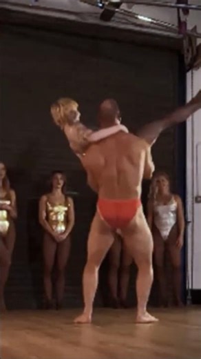 Bodybuilder presses woman overhead