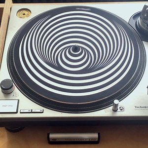 7.2K views · 38 reactions | ❗WARNING❗ Our Ed Hertz record mat can induce altered states of being. Side effects include vertigo, nausea, and dizziness. Use with caution. ↳ get yours here: turntablelab.com/EdHertz | Turntable Lab | Facebook