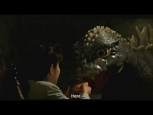 Baby Godzilla eating a burger