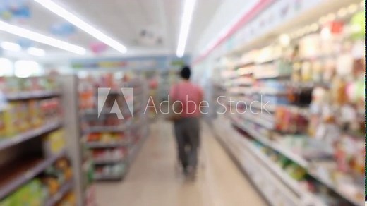 Customer shopping in supermarket convenience store aisle interior shelves blur background