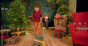 Young boy angrily throws his Christmas present to the ground and kicks it