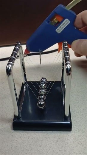 Newton's Pendulum. Gluing the Central Balls