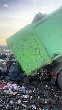 Garbage trucks unloading at the landfill