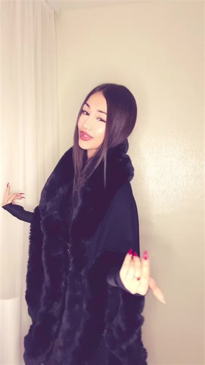 Creative Hand Gestures in Black Fur Coat Performance