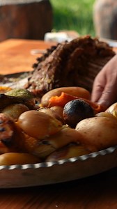 Tender meat, vegetables cooked in an earth oven, steaming and fragrant. A traditional outdoor feast. #EarthOvenCooking #OutdoorCooking #TraditionalRecipe #Cooking | Wilderness Grill