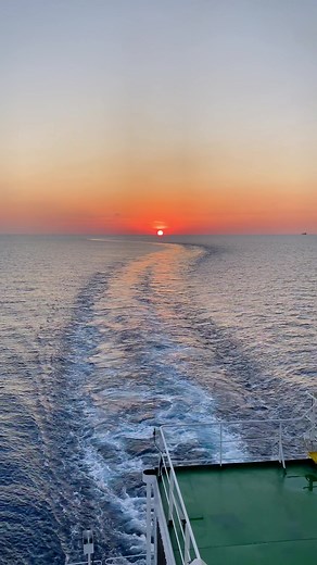 Serene Ocean Sunset from a Ship's Deck