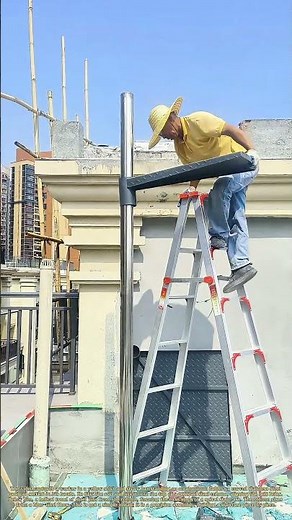 Bolting the Spiral: How a Worker Assembles a Stainless Steel Staircase